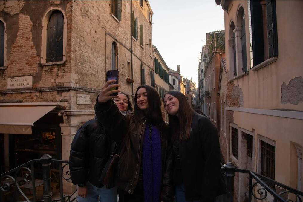 Three friends taking a selfie in a town